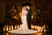 husband and wife surrounded by candles for romantic wedding photos in New Jersey.