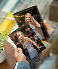 Photo prints being held by a client in the Adam Hommerding Photography Studio