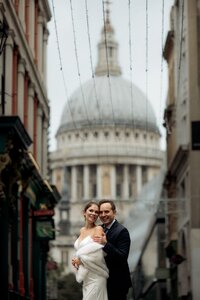 Candid moment couple kissing and gigetting after getting  married at Old Marylebone town hall in London