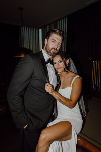 bride and groom portrait on pool table before reception