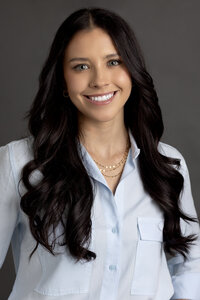 Professional branding headshot of young business professional in Northville studio.