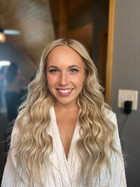 Bride after makeup in white robe