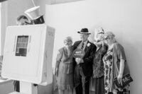 Wedding guests dance underneath ambient market lighting