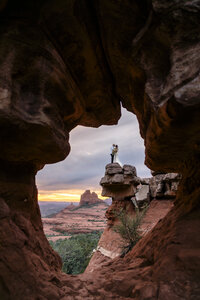 bride and groom posing in front of merry go round rock