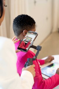 Content creation setup for entrepreneurs featuring a professional cellphone and tripod, tools used in brand photography to capture strategic visuals