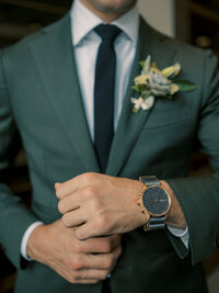 photo of groom in a green suit before his wedding at district winery in washington dc