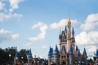 Photo of Cinderella's Castle in Magic Kingdom with blue sky and fluffy clouses