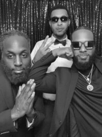 glam photo booth image in black and white of three men at a wedding