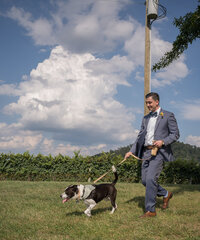 Groom walking his dog to elopement.