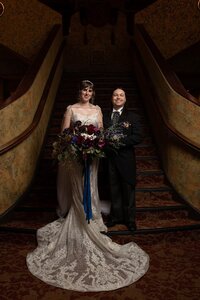 Bride and groom standing on staircase in theatre