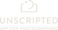 A white version of the logo for the company 'Unscripted'.