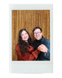 Taressa and her husband smile in their rental photo booth at an event in Oregon