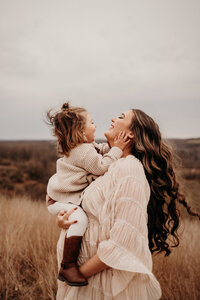mother and daughter playing and hugging