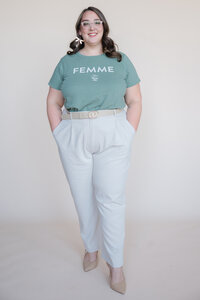 Rachel standing with hands in pockets smiling