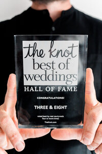 photographer holding a knot best of weddings award