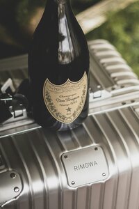 Champagne sitting on top of luggage
