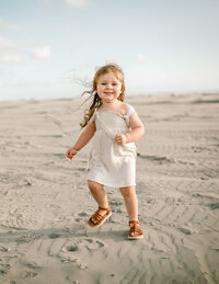 Family photographer photographed family session in Discovery Park on the beach