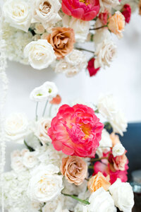 Bride holding bouquet of blush, white and orange florals