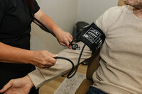 Close up of a nurse checking a male patient's blood pressure at Rocky Mountain Wellness Clinic in Idaho Falls, ID.