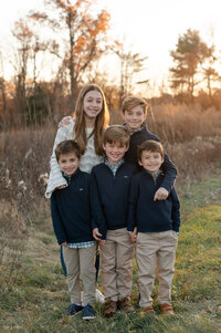 five kids outside smiling