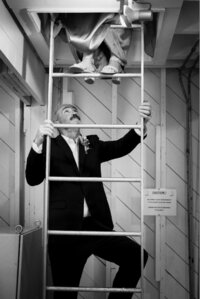 Groom following bride up ladder at Nova Scotia Lighthouse Elopement.