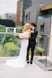 Elopement Photography, couple standing cuddled on a rooftop