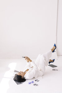 Tarah lying on floor on her phone