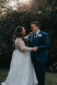 bride and grooms first dance in the garden at golden hour