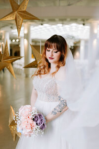A bride holds her bouquet in the Grotto at Contemporary Calgary