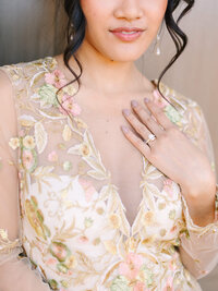 bride wearing engagement ring cropped photo