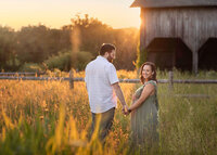 NJ maternity photos of couple in front of barn