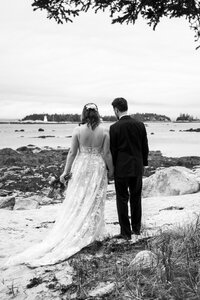 Bride and groom take in the view at Oceanstone Beach Resort, photographed by Candid Nova Scotia wedding photographer. 