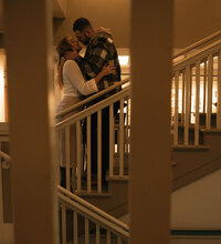A couple sharing a quiet, intimate moment among the bookshelves during a cozy library couple photography session in Spokane, Washington.