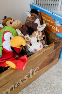 Bin of stuffed animals sitting in a child's room
