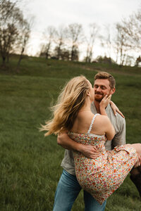 Joyful couple spinning during their Kentucky engagement, full of love and movement.
