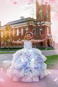 girl in a dress standing in front of  Fulton County Courthouse in Wauseon
