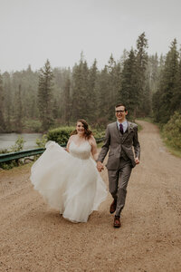 bride and groom holding hands walking