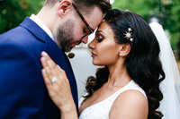 bride-and-groom-embrace-at-luxury-wedding-at-foxhills-in-surrey-by-leslie-choucard-photography