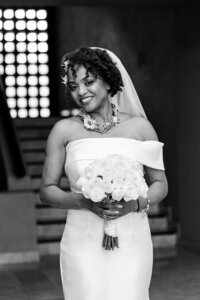 Black and white photo of a bride holding her wedding bouquet