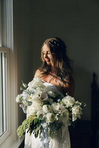 Bride with flowers at the somers mansion near flathead lake