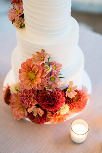 Orange and red flowers for a white cake