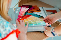 Woman holding pantone color swatches