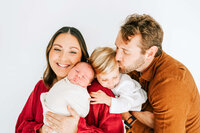 Springfield MO maternity photographer captures pregnant couple cuddling in studio