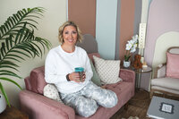 Kate Lemish sitting on couch with cup of tea