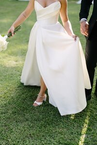 bride's wedding dress showing her shoes and bouquet