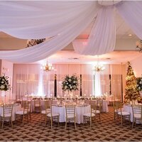 Wedding guests dance underneath ambient market lighting