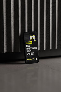 Instagram story post on phone against black wall