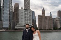 Black lash tech and makeup artist blowing setting powder in a photography studio during branding photoshoot in Indiana.