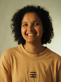 young woman in a yellow shirt, smiling