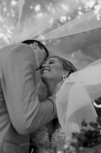 The-groom-reaches-out-to-kiss-the-bride-and-she-smiles